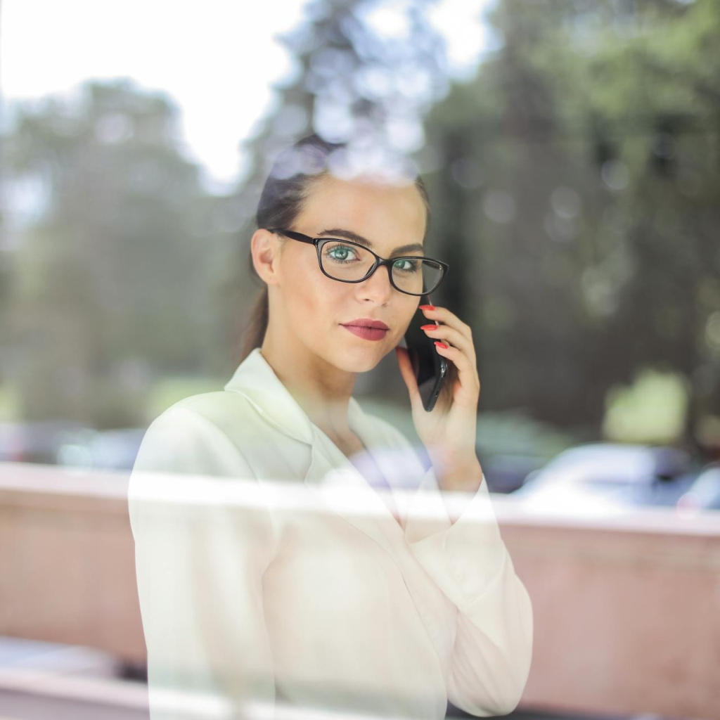 Women with phone behind the window